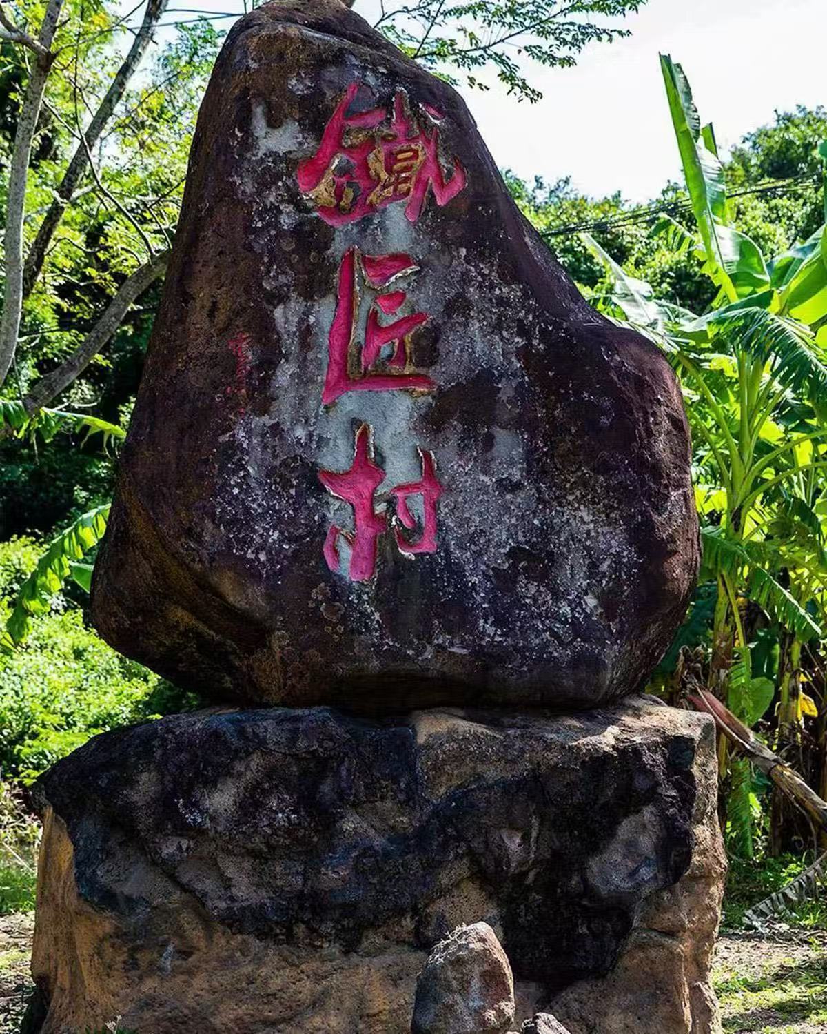 刻有铁匠村三个红字的村庄石碑
